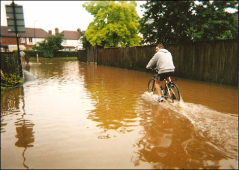 Flooding in Alcester - riding a bike through water