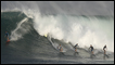 Six surfers ride a wave in Waimea, Hawaii