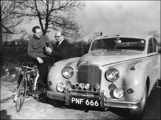 Bisiklet şampiyonu Reg Harris ve BBC Türkçe'den Mehmet Refiğ. Yanlarında ise Harris'in, Monte Carlo Rallisi'ne katıldığı ama bir motor arızası nedeniyle yarışı tamamlayamadığı araba var. 03/02/1956 © BBC