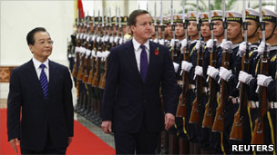 Wen Jiabao and David Cameron walk past troops