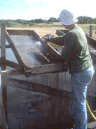 Photo of an archaeologist washing through soil