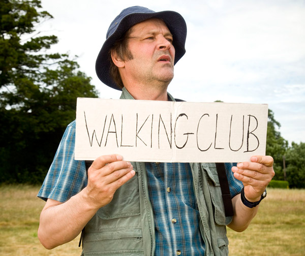 Mark Heap holding a Walking Club sign