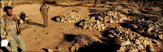 ONLF Fighters inspect mass graves in the Ogaden