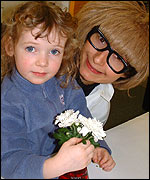 Laura puts her flowers into the coloured water!