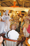 A young boy watches as his protector orixas dance before him