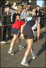 A couple walking up the steep Mow Cop Hill