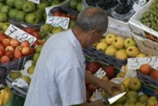 Man buying fruit at a market stall