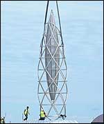The spire is lowered into place