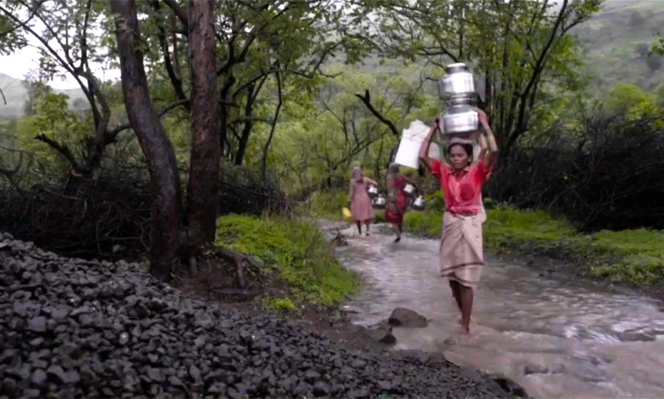 Women walking through a stream.