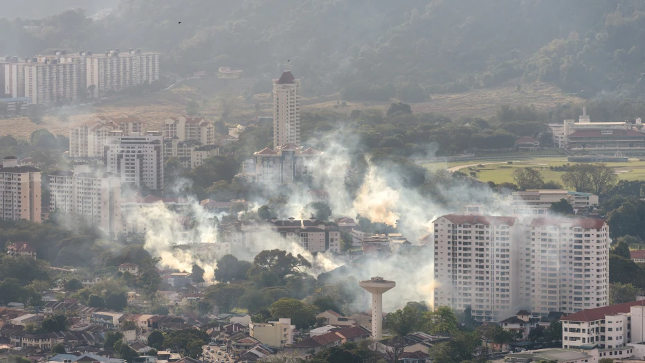 A city with fumes rising from it.