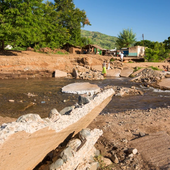 A riverbank where a bridge has collapsed.
